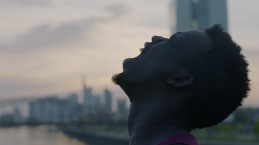 A man is looking up and screaming towards the sky