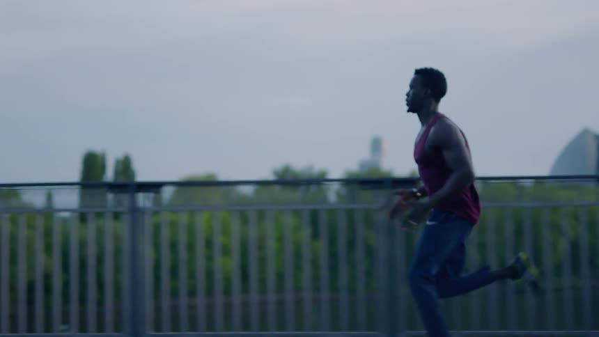 A man runs across a bridge