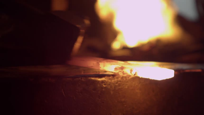 Person hammering out hot metal