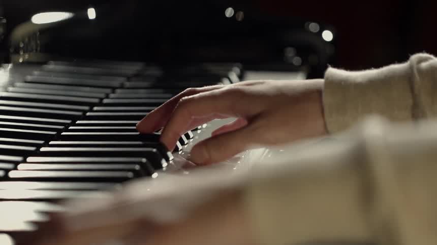 A woman plays a piano