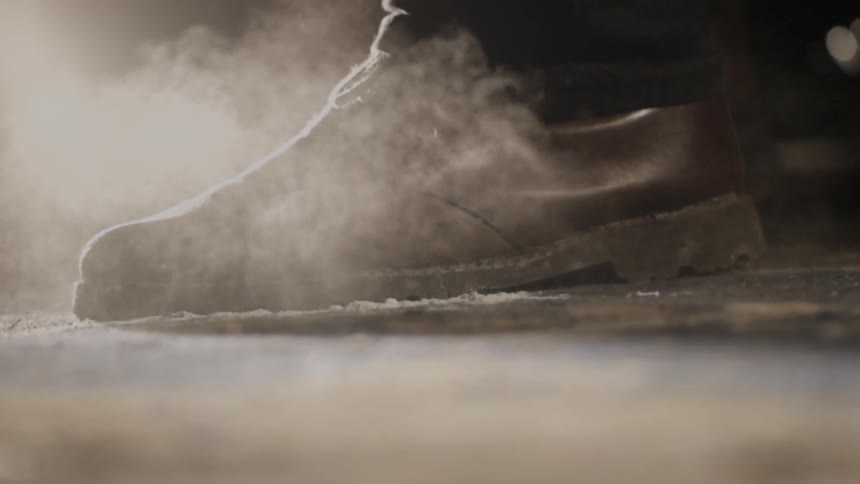 A person jumps on the ground throwing dirt up