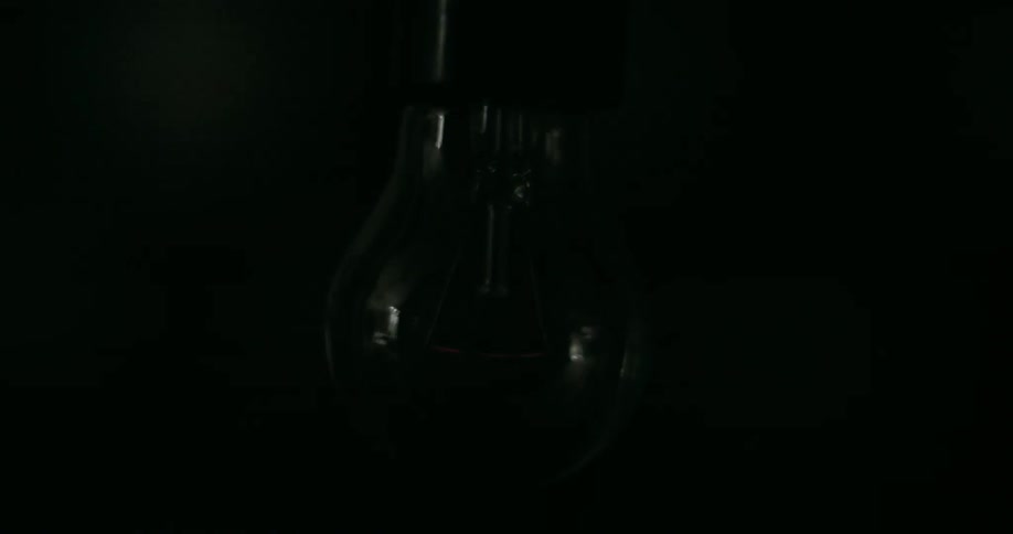 A tungsten light bulb is flashing on and off