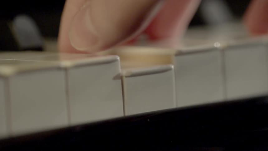 Close up of someone pressing a piano key