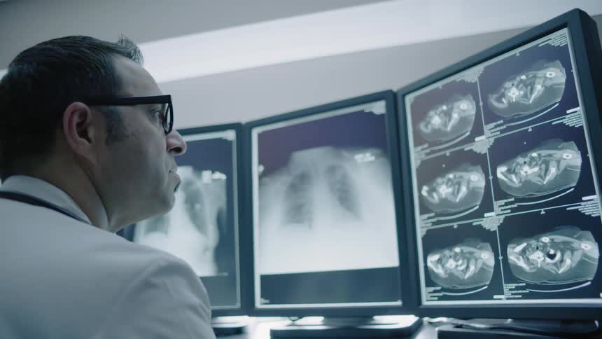 A doctor is examining a person's results in a lab