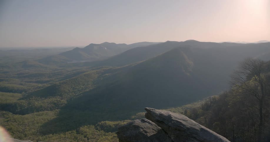 Mountains sit under a bright sun