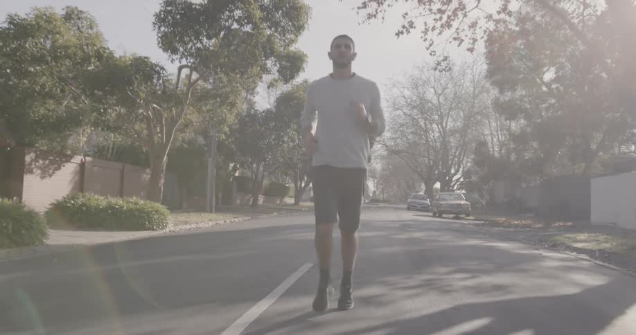 A man is running down the middle of the street