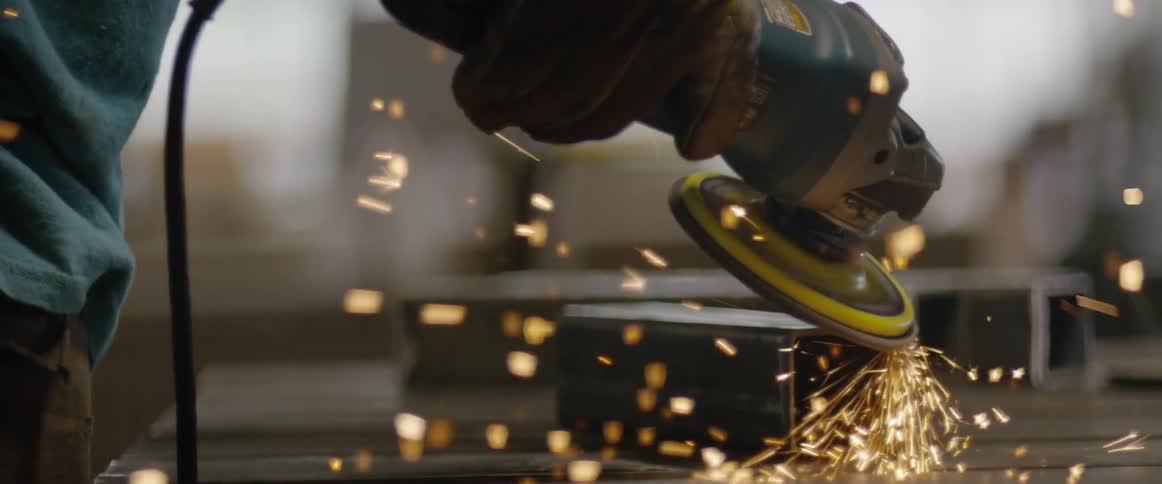 Someone is using a grinder on a piece of metal