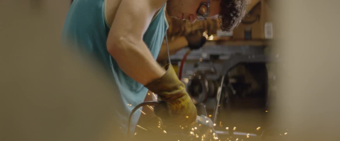 Man uses a saw to cut metal
