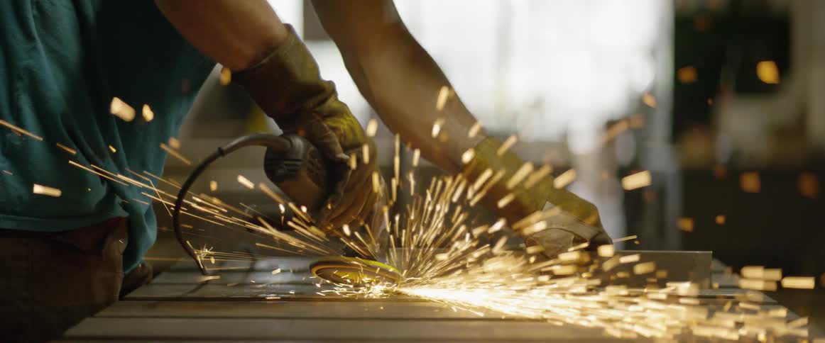 Sparks fly from power tool in a workshop