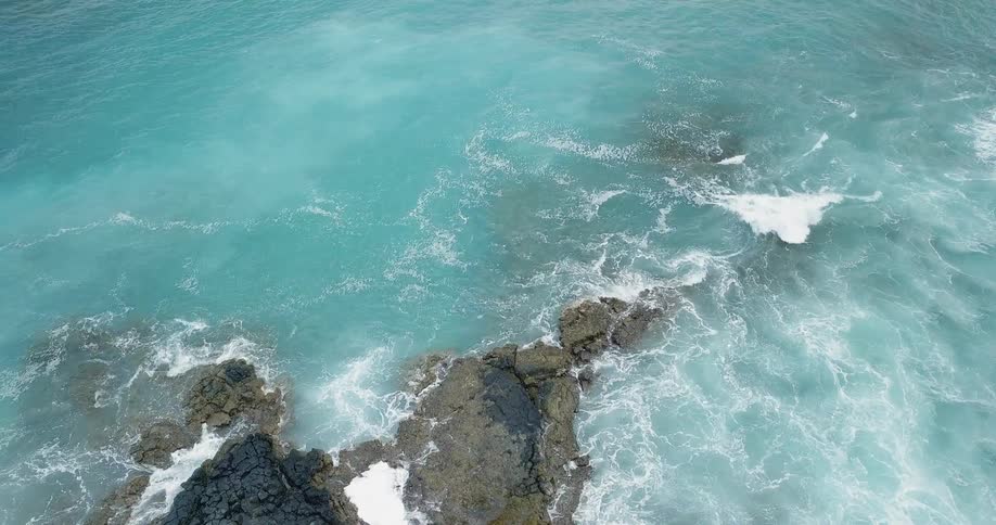 Waves crash onto a rocky shore