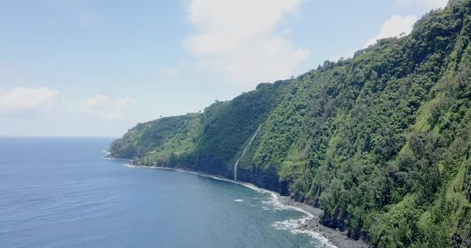 An island with a waterfall that's draining into the ocean