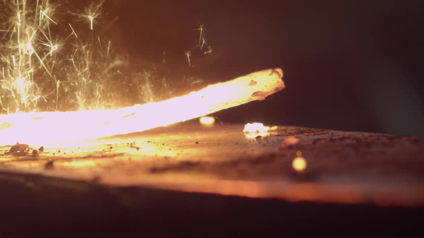 Man forging hot metal with a hammer