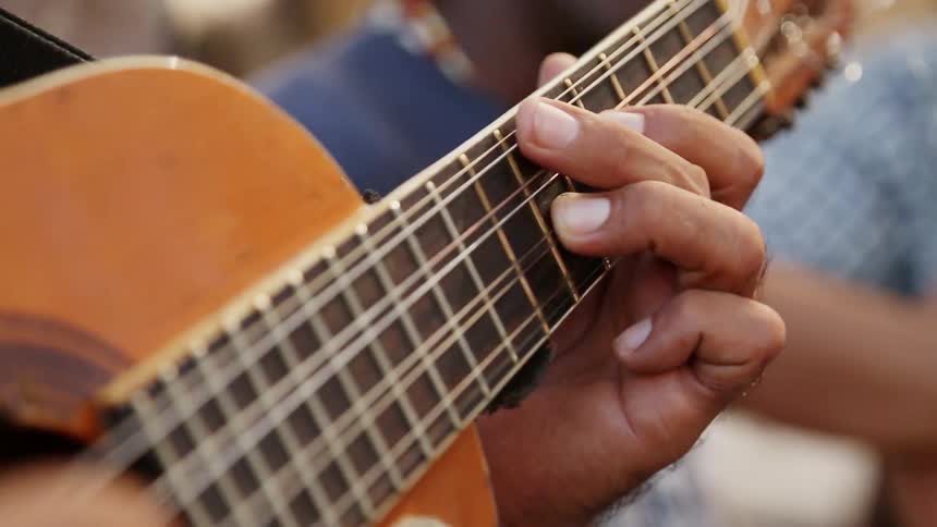 A Cuban man plays a guitar
