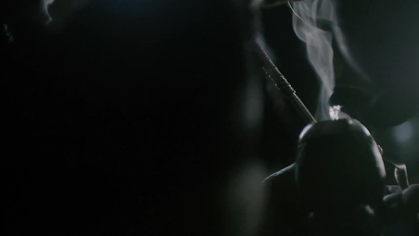 Steam is coming off a pot in a dark room