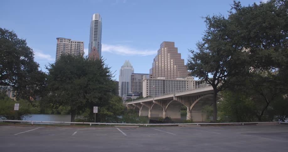 A city skyline as seen from a nearby parking lot