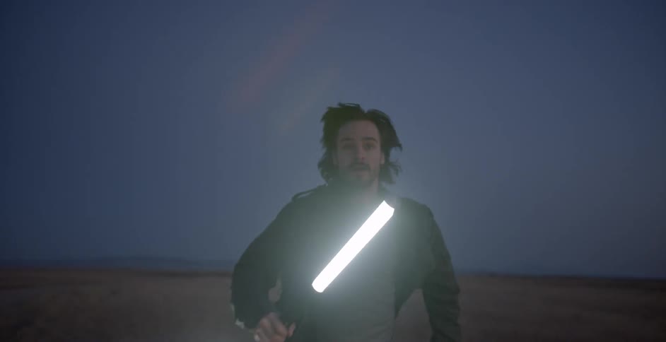 Someone is running through the desert with a bright white light in their hands