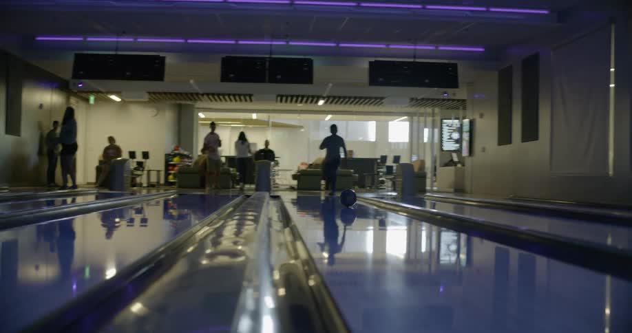 People are bowling in a bowling alley