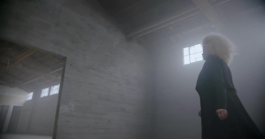 A woman walks through a warehouse