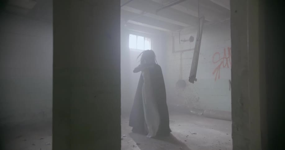 Woman dances in an empty warehouse