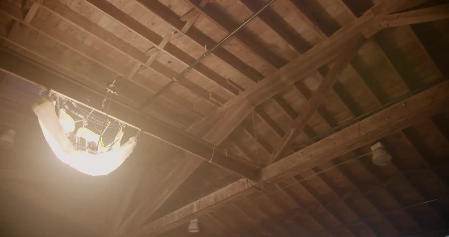 Spotlights hang from a wooden beam