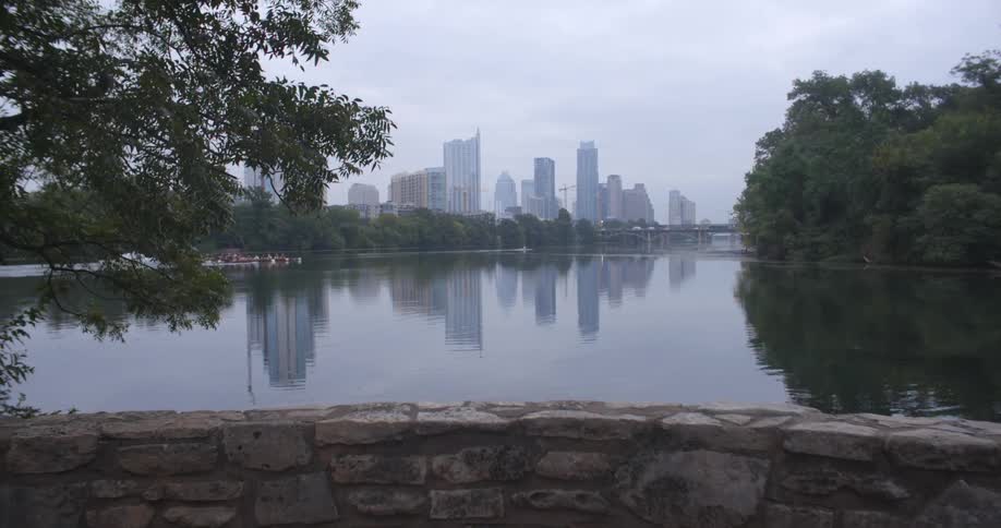 View of a large city from one side of a lake on a cloudy day