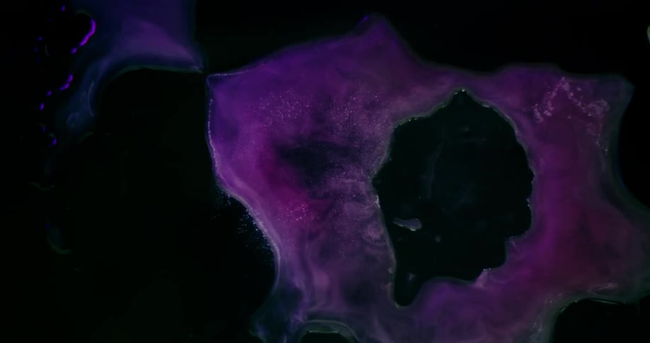 The liquid has purple swirls moving around