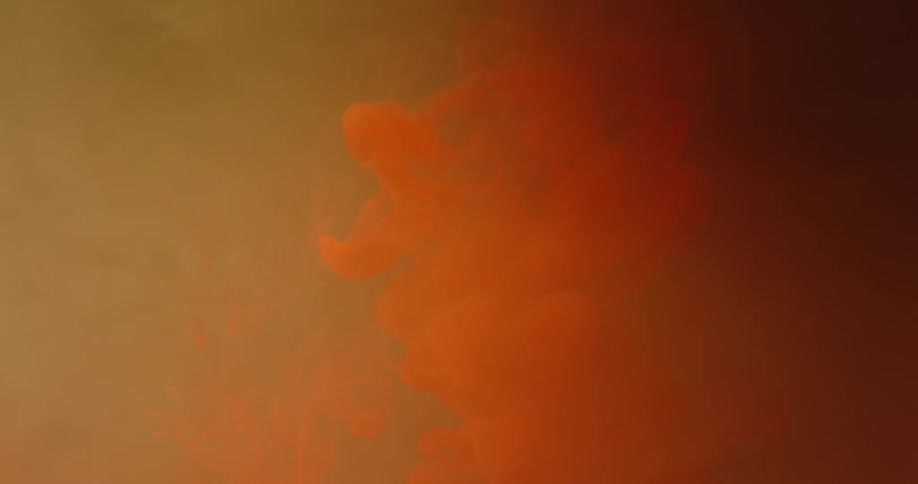 Orange smoke is hanging in the air
