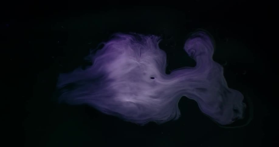 The dark water has a large white swirl in the middle