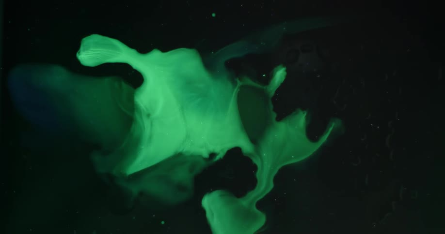 Green liquid moves around in the container