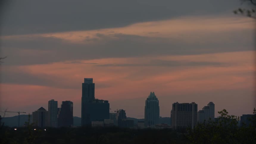 Timelapse of clouds rolling over a city skyline