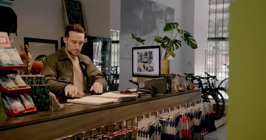 Man working at desk inside of a bike shop