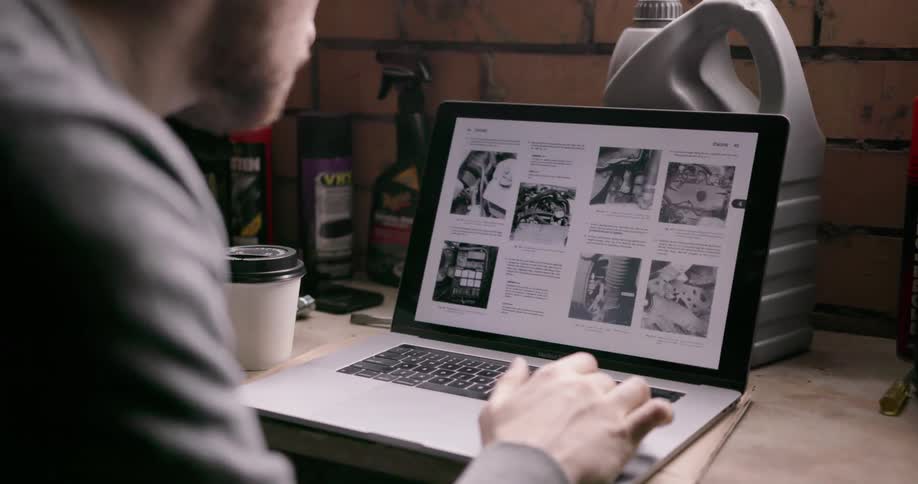 Someone is looking at design plans on a laptop in a workshop