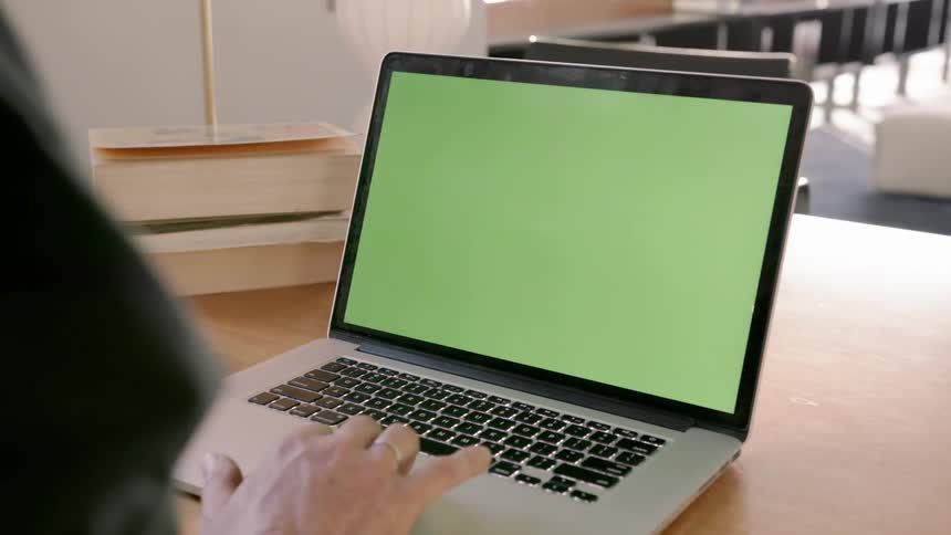 A person types on a laptop