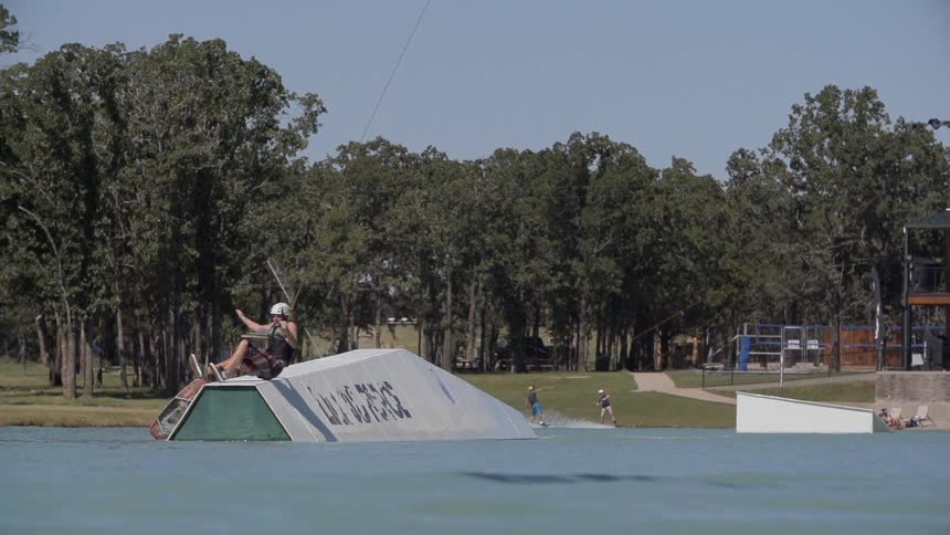 A person does tricks while water skiing