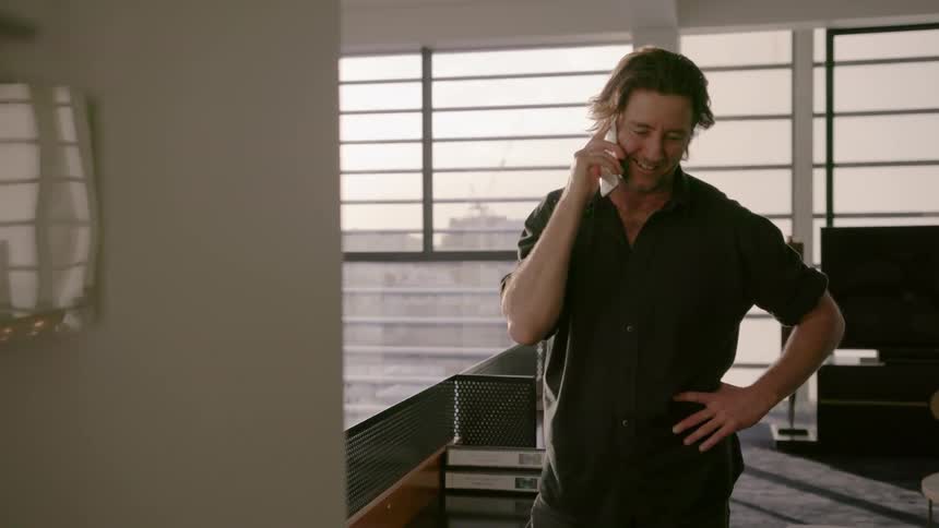 Man talking on phone in apartment