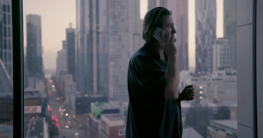Man talks on the phone in a city