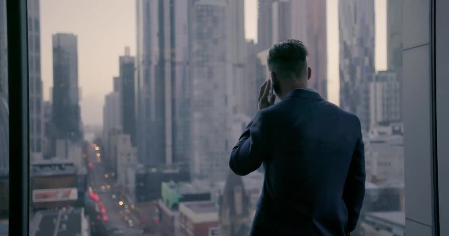 Man talks on a phone in a city office