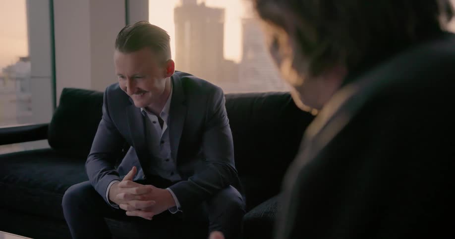 Businessmen sitting and talking indoors in a big city