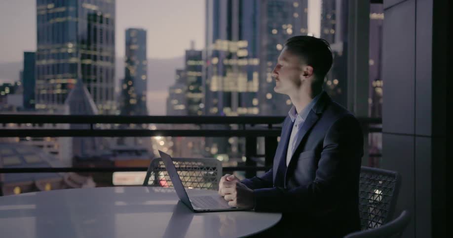 Man works at laptop in office