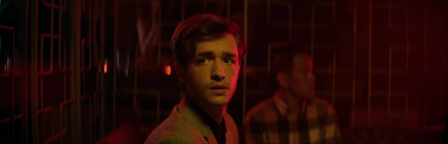 Man in club staring at something in the distance