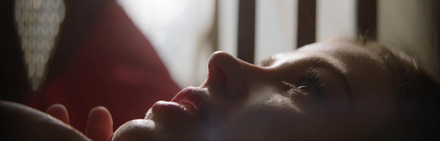A man kisses a woman in bed