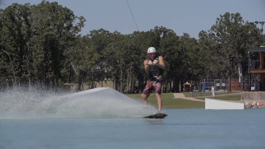 Wakeboarder gliding across the surface of the water