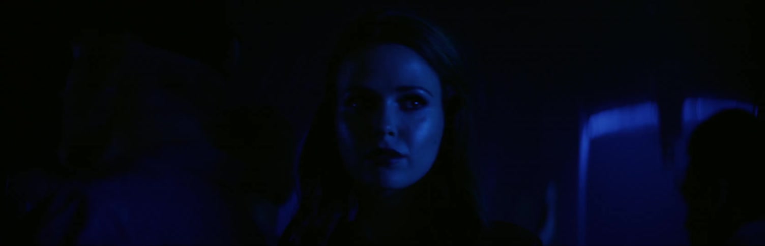 Woman walking through club looking for someone