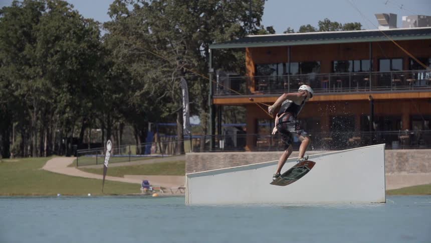 Person wakeboarding off a jump into the water
