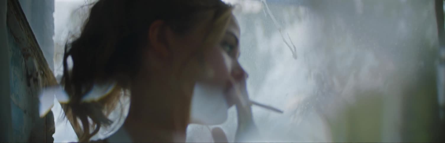 Woman Smoking A Cigarette By An Open Window