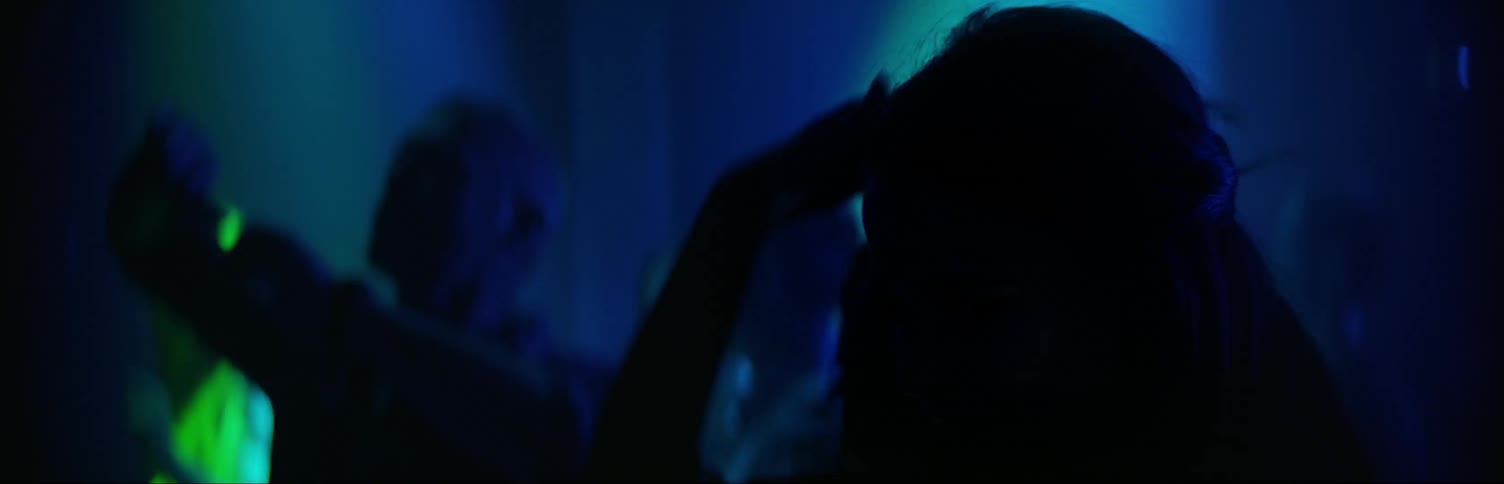 A woman is dancing at a club at night