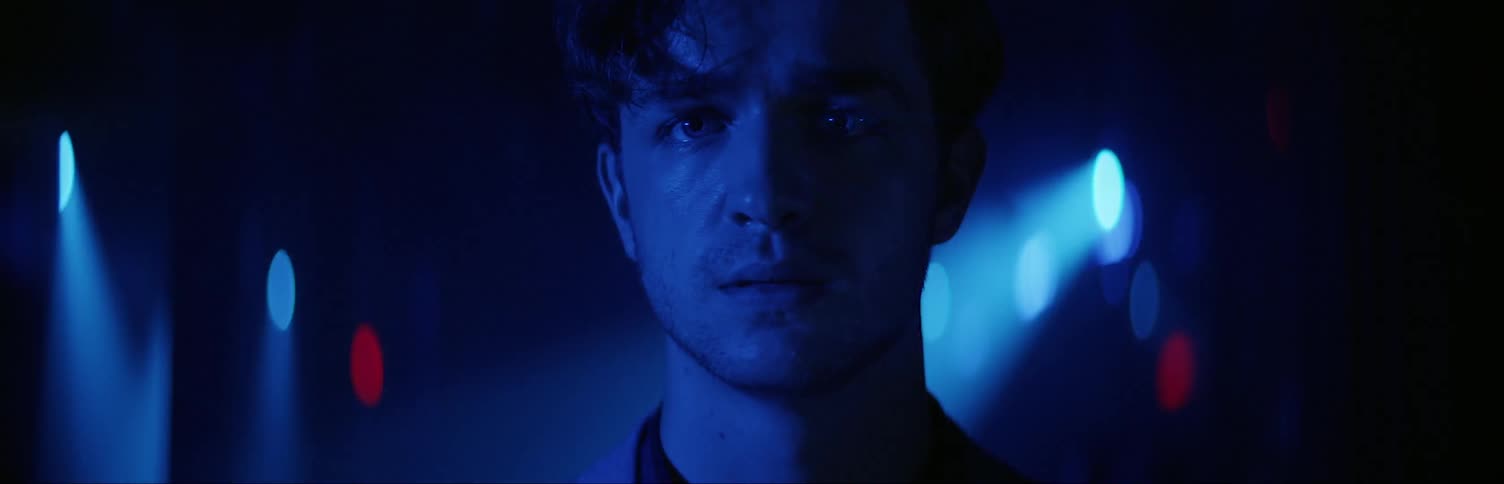 A man looks forward worried in the dark club