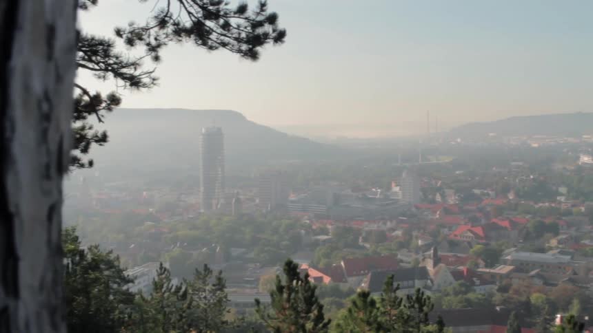 A small town is shown on a misty day