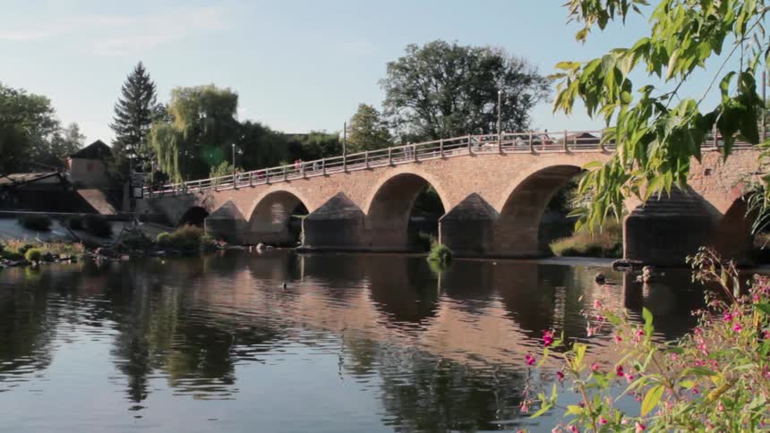 River Flowing Under Bridge In City
