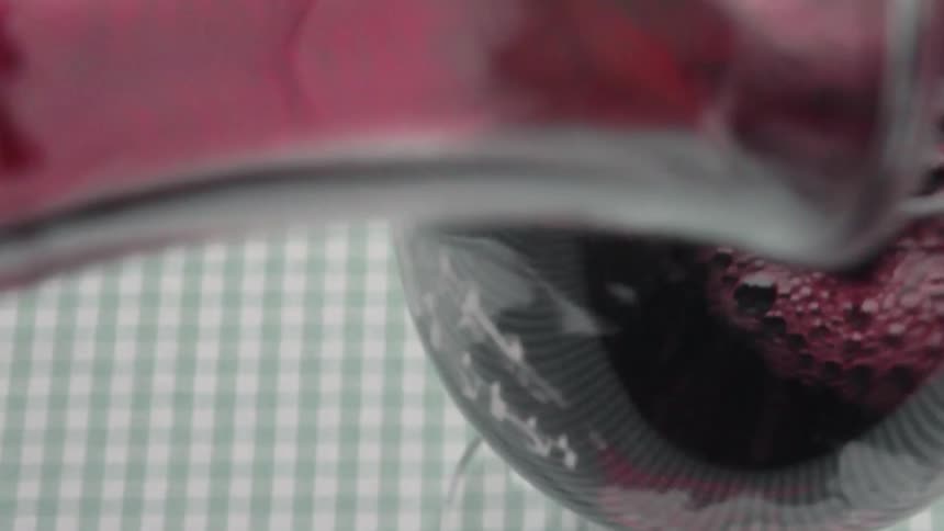 The glass is being filled with wine